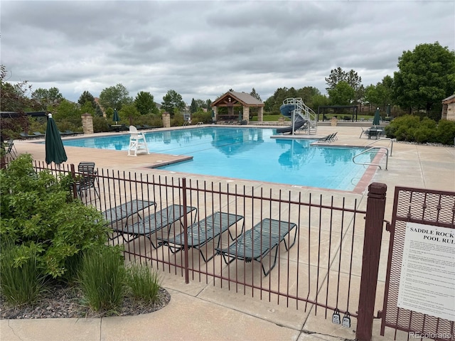 6323 S Sicily Way, Aurora, CO 80016 - community pool featuring a gazebo, a patio, and a water slide