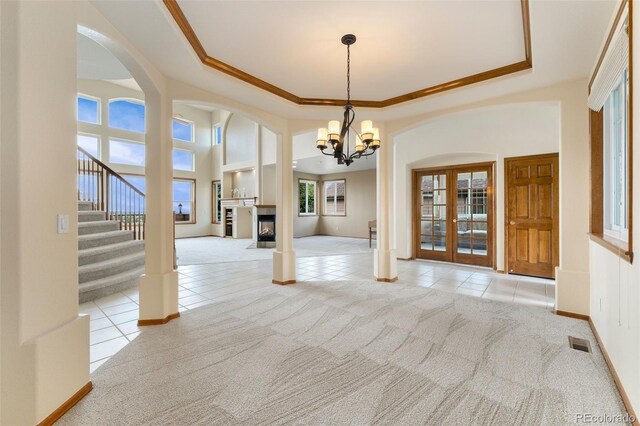 6323 S Sicily Way, Aurora, CO 80016 - unfurnished dining area featuring light carpet, light tile patterned floors, arched walkways, baseboards, and ornamental molding
