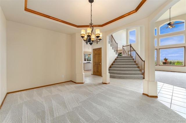 6323 S Sicily Way, Aurora, CO 80016 - unfurnished room with light colored carpet, a tray ceiling, baseboards, stairway, and a chandelier