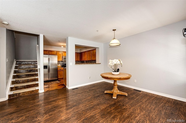 dining space with baseboards, dark wood-style flooring, and stairway