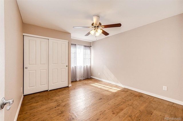 unfurnished bedroom featuring baseboards and wood finished floors