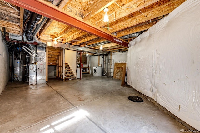 unfinished basement with heating unit, gas water heater, stairs, and washer / clothes dryer