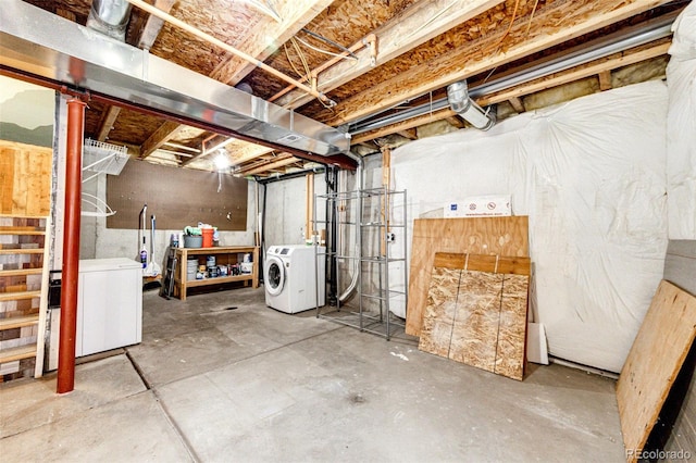 unfinished basement with refrigerator and washing machine and clothes dryer
