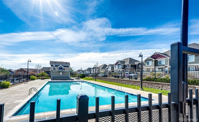 view of pool featuring a residential view, fence, and a fenced in pool