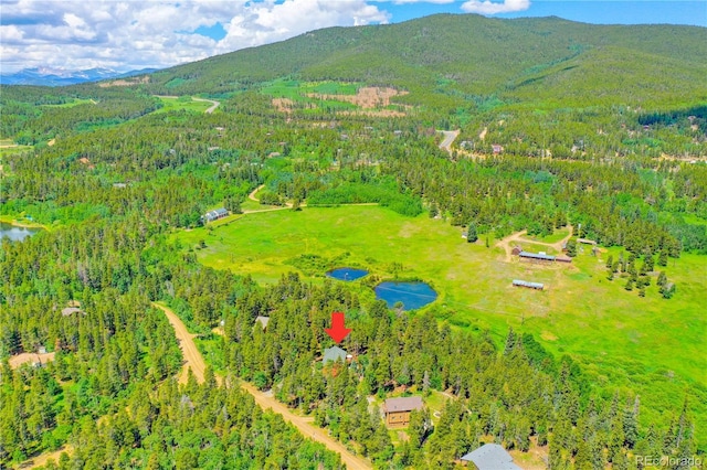 aerial view featuring a water and mountain view