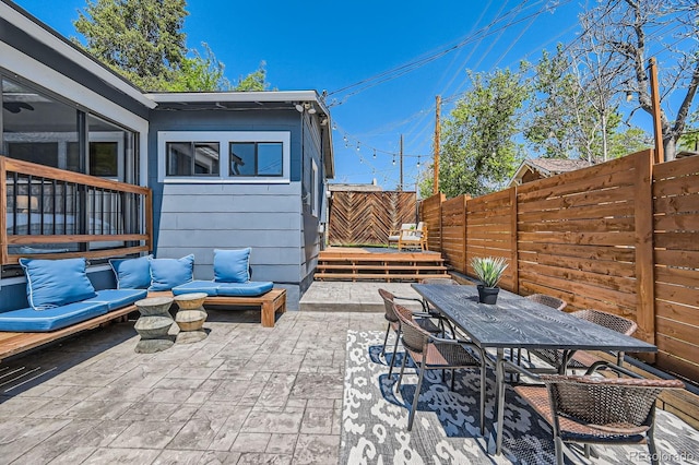 view of patio / terrace featuring a fenced backyard, outdoor dining space, and an outdoor living space