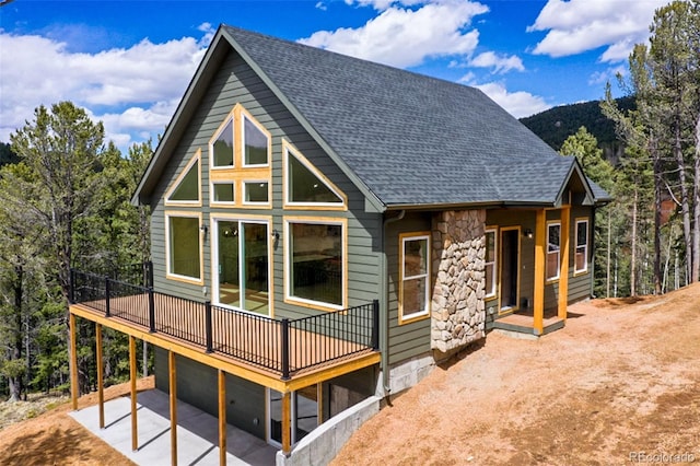 198 Timber Ridge Rd, Divide, CO 80814 - exterior space featuring a garage, stone siding, a patio, a shingled roof, and concrete driveway