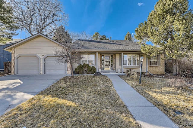 ranch-style house with a garage, concrete driveway, brick siding, and roof with shingles