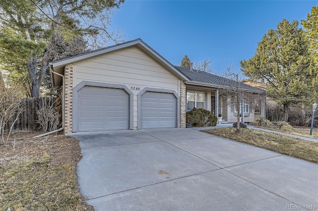 ranch-style house featuring a garage, brick siding, and driveway