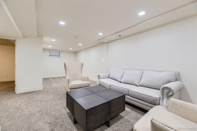 carpeted living room featuring baseboards, visible vents, and recessed lighting