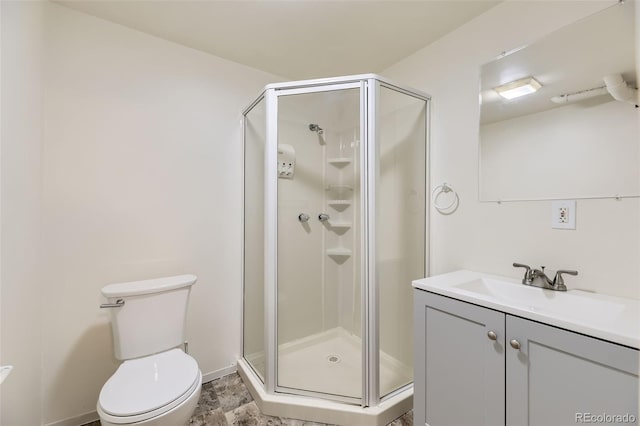 full bath with a stall shower, vanity, and toilet