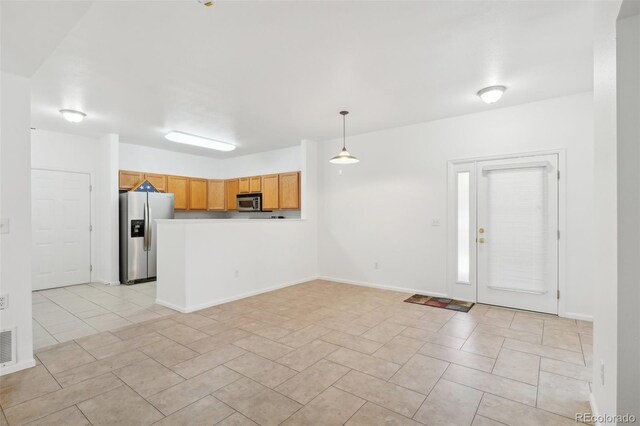 2502 S Bahama Cir Unit B, Aurora, CO 80013 - unfurnished living room featuring light tile patterned floors and baseboards