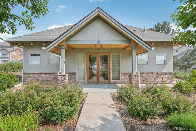2502 S Bahama Cir Unit B, Aurora, CO 80013 - view of exterior entry featuring stucco siding, stone siding, and french doors