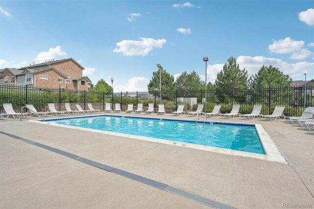 2502 S Bahama Cir Unit B, Aurora, CO 80013 - community pool featuring a patio and fence