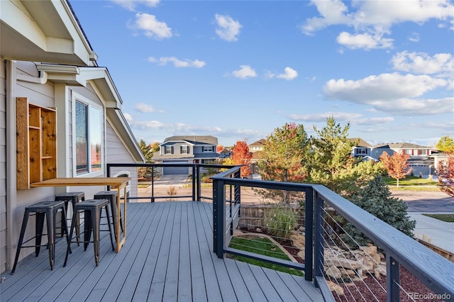 deck featuring a residential view and an outdoor bar