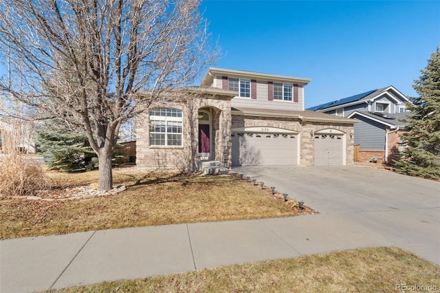 view of front of property featuring stone siding and concrete driveway