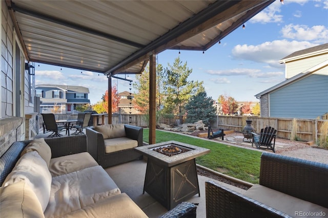 view of patio featuring a fenced backyard and an outdoor living space with a fire pit