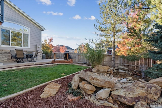 view of yard with a fenced backyard and a patio