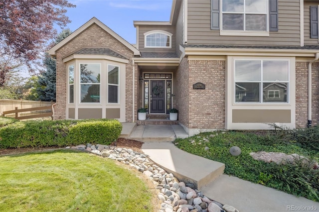 doorway to property with a yard