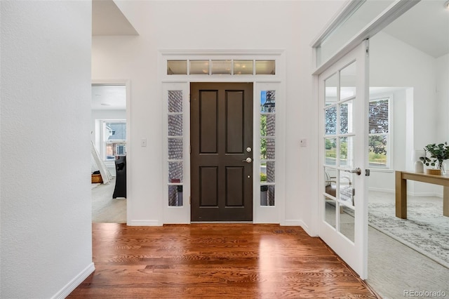 entryway with dark hardwood / wood-style flooring and french doors