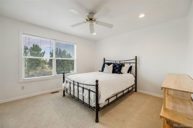 bedroom featuring light colored carpet and ceiling fan