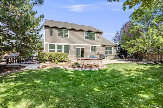 rear view of property featuring a patio and a lawn