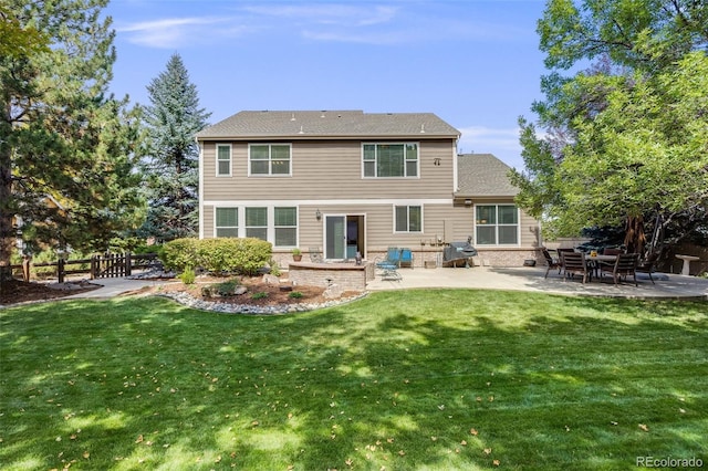 back of house with a patio and a yard