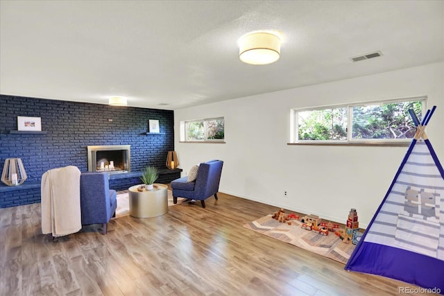 400 S Hoyt St, Lakewood, CO 80226 - rec room with wood finished floors, baseboards, and a fireplace