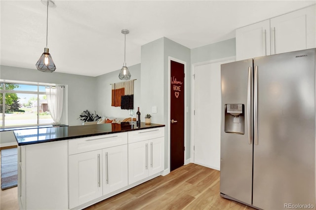 400 S Hoyt St, Lakewood, CO 80226 - kitchen with stainless steel fridge, light wood-type flooring, white cabinets, and dark countertops