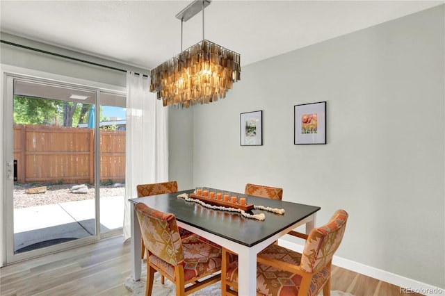 400 S Hoyt St, Lakewood, CO 80226 - dining space featuring a chandelier, wood finished floors, and baseboards