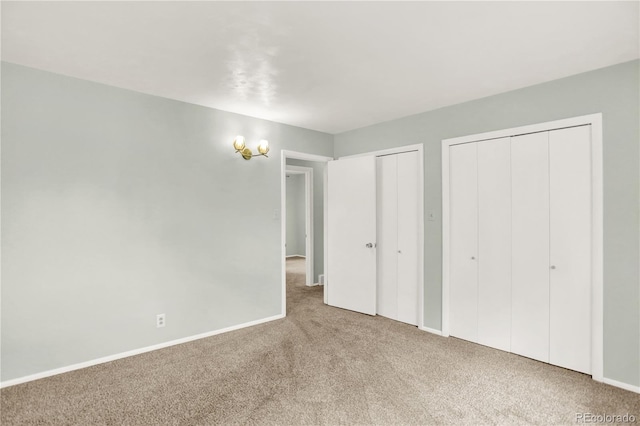 400 S Hoyt St, Lakewood, CO 80226 - unfurnished bedroom with multiple closets, carpet, and baseboards