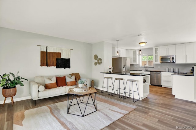 400 S Hoyt St, Lakewood, CO 80226 - living area with light wood-style flooring and baseboards