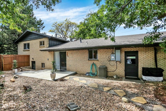 400 S Hoyt St, Lakewood, CO 80226 - back of house with brick siding, a patio, roof with shingles, and central AC