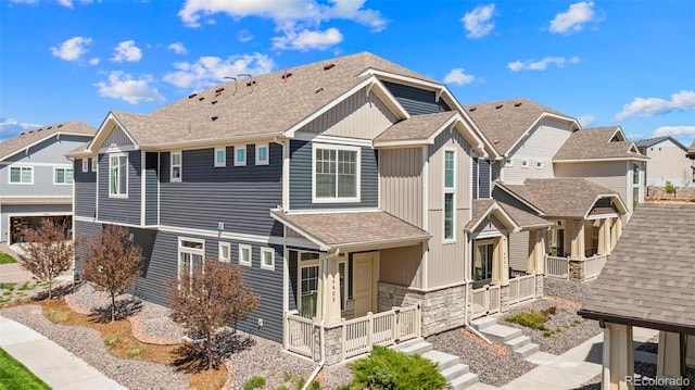 6405 Glencullen Vw, Colorado Springs, CO 80927 - view of side of property featuring stone siding, a shingled roof, a residential view, and covered porch