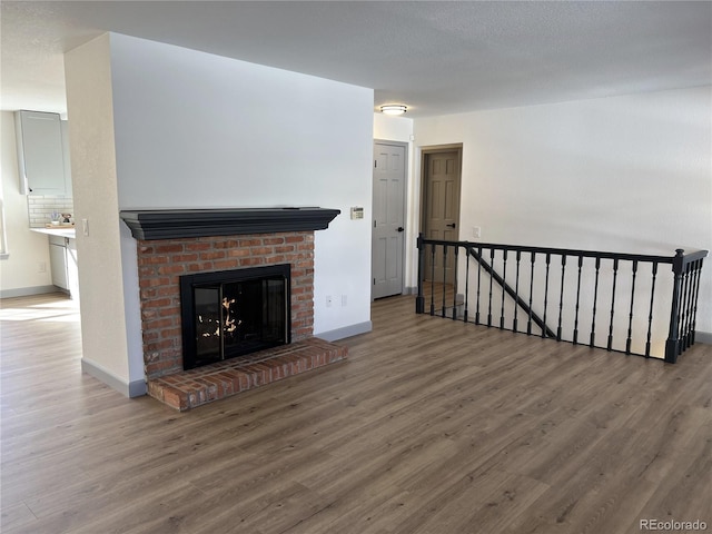 living room featuring wood-type flooring and a fireplace