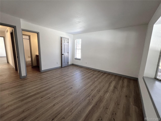 empty room with dark wood-type flooring