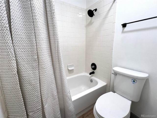 bathroom with shower / bath combination with curtain and toilet