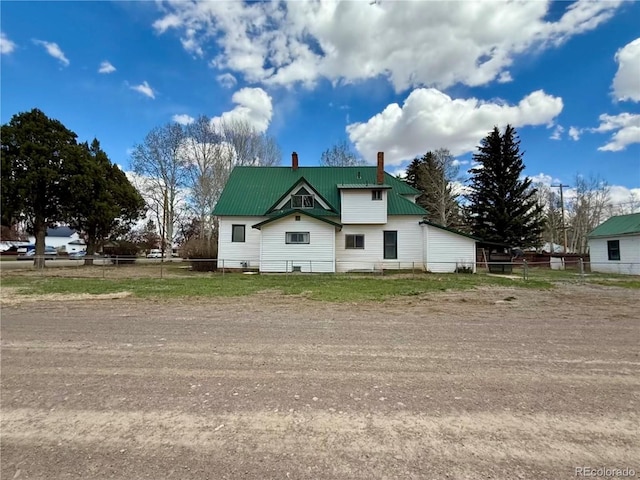 104 Joe S Chavez Dr, La Jara, CO 81140 - view of side of home featuring a chimney and a metal roof