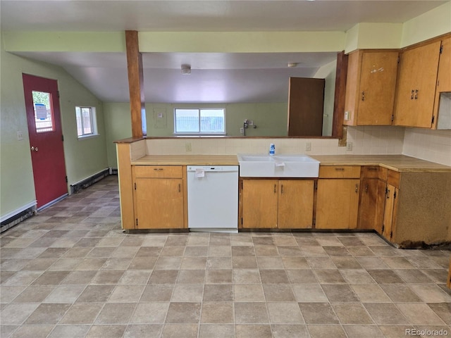 104 Joe S Chavez Dr, La Jara, CO 81140 - kitchen featuring dishwasher, backsplash, light countertops, brown cabinetry, and lofted ceiling
