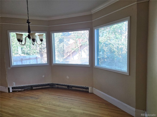 104 Joe S Chavez Dr, La Jara, CO 81140 - unfurnished dining area featuring a chandelier, ornamental molding, wood finished floors, and baseboard heating