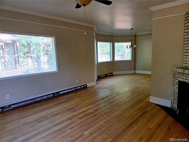104 Joe S Chavez Dr, La Jara, CO 81140 - unfurnished living room featuring wood finished floors, a ceiling fan, crown molding, and a baseboard radiator