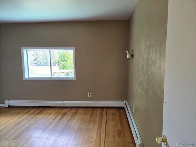 104 Joe S Chavez Dr, La Jara, CO 81140 - spare room featuring hardwood / wood-style floors and a baseboard radiator