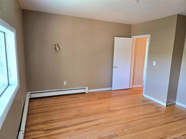 104 Joe S Chavez Dr, La Jara, CO 81140 - empty room with light wood finished floors and baseboard heating