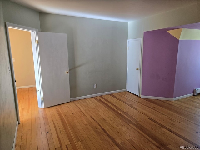 104 Joe S Chavez Dr, La Jara, CO 81140 - unfurnished room with wood-type flooring and a baseboard heating unit
