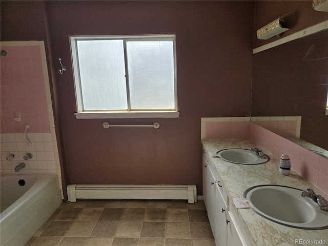 104 Joe S Chavez Dr, La Jara, CO 81140 - full bath featuring a baseboard radiator, double vanity, tile patterned flooring, and washtub / shower combination