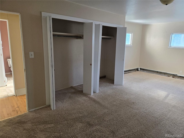 104 Joe S Chavez Dr, La Jara, CO 81140 - unfurnished bedroom featuring two closets, carpet flooring, and a baseboard radiator