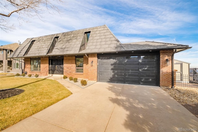 view of front of house with a front yard and a garage