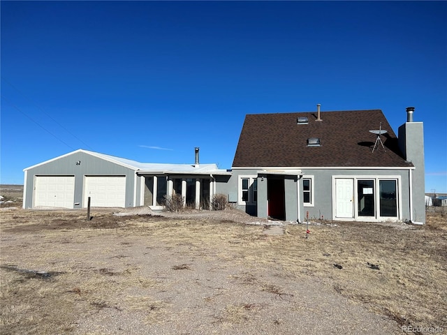 back of house featuring a garage