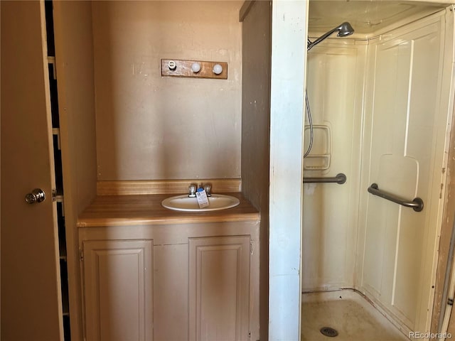 bathroom featuring walk in shower and vanity