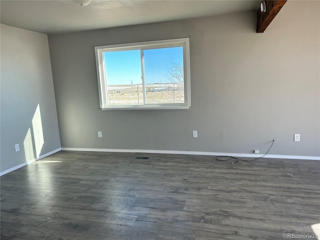 empty room featuring dark hardwood / wood-style flooring